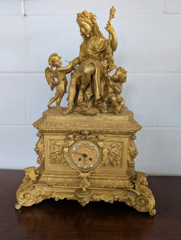 Gilt bronze mantel clock with female figure and putti