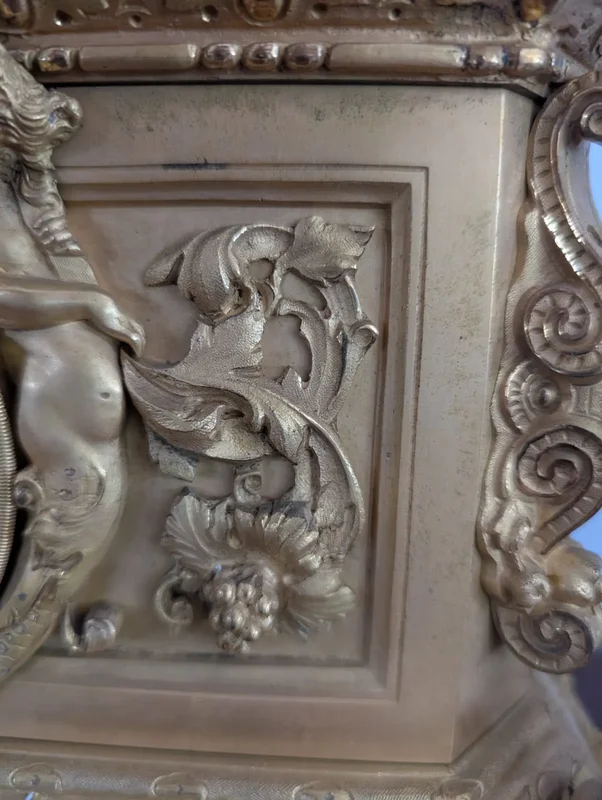 Gilt bronze mantel clock with female figure and putti