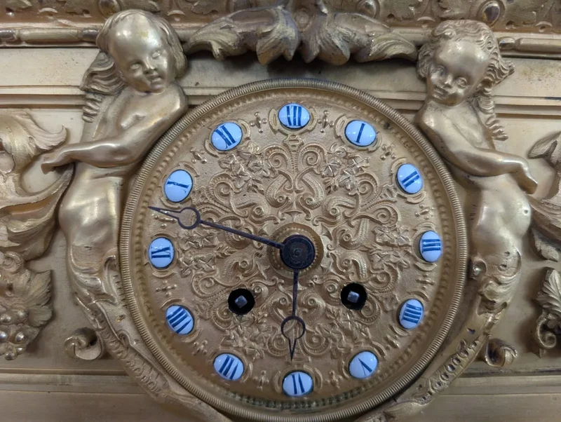 Gilt bronze mantel clock with female figure and putti
