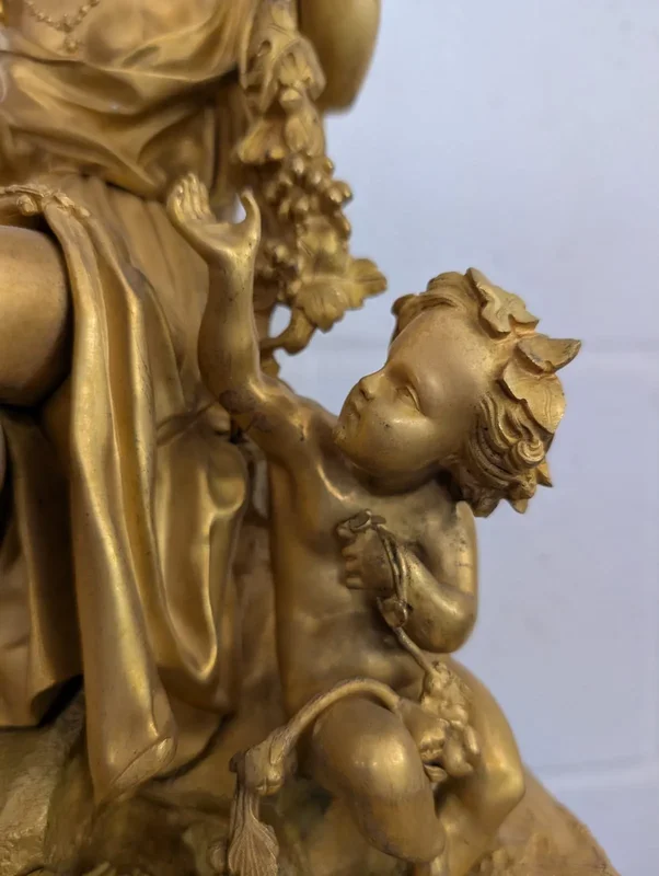 Gilt bronze mantel clock with female figure and putti