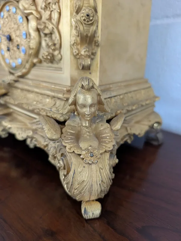 Gilt bronze mantel clock with female figure and putti