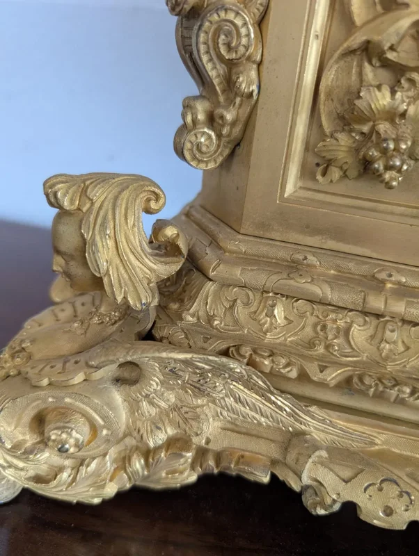 Gilt bronze mantel clock with female figure and putti