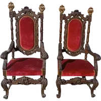 Paire de fauteuils anciens en noyer sculpté