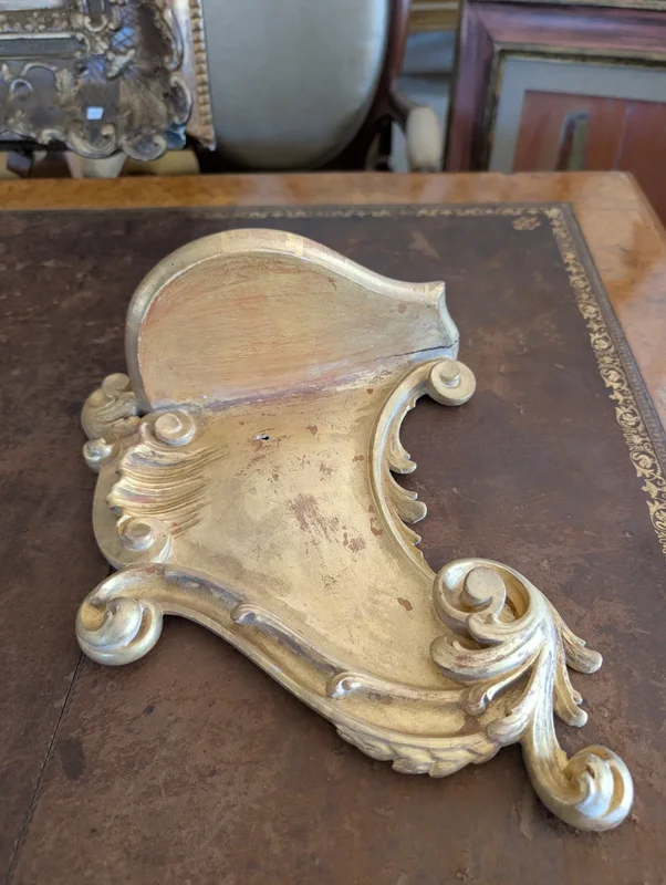 Carved and gilded wooden decorative shelf with rocaille scrolls