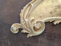 Carved and gilded wooden decorative shelf with rocaille scrolls