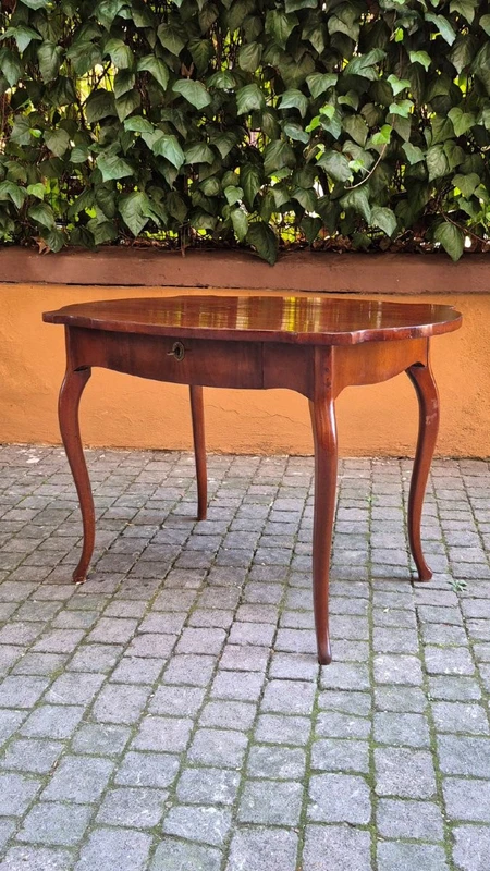 Moved antique walnut panelled writing table